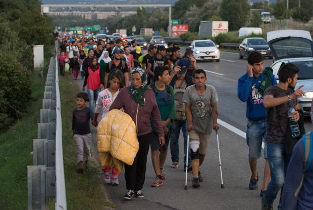 BUDAPEST, HUNGARY - SEPTEMBER 04: Migrants begin walking towards the Austrian border on September 4, 2015 in Bicske, near Budapest, Hungary. Several thousand migrants began walking today towards Austria after all international trains to Western Europe remained cancelled. (Photo by Matt Cardy/Getty Images)
