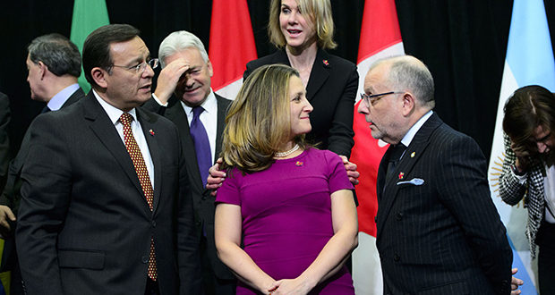 United States Ambassador to Canada Kelly Craft places her hands on the shoulders of Minister of Foreign Affairs Chrystia Freeland during a family photo at the 10th ministerial meeting of the Lima Group in Ottawa on Monday, Feb. 4, 2019. THE CANADIAN PRESS/Sean Kilpatrick